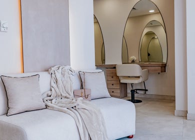 Elegant seating area at Lish Beauty Bar, Dubai, Dubai, AE, featuring a plush sofa and stylish decor.