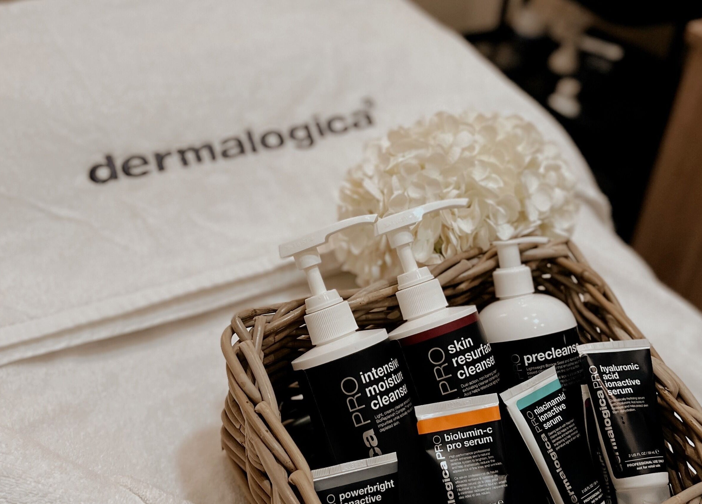 Dermalogica products at Lish Beauty Bar - JLT, Dubai, Dubai, AE, displayed with delicate flowers.