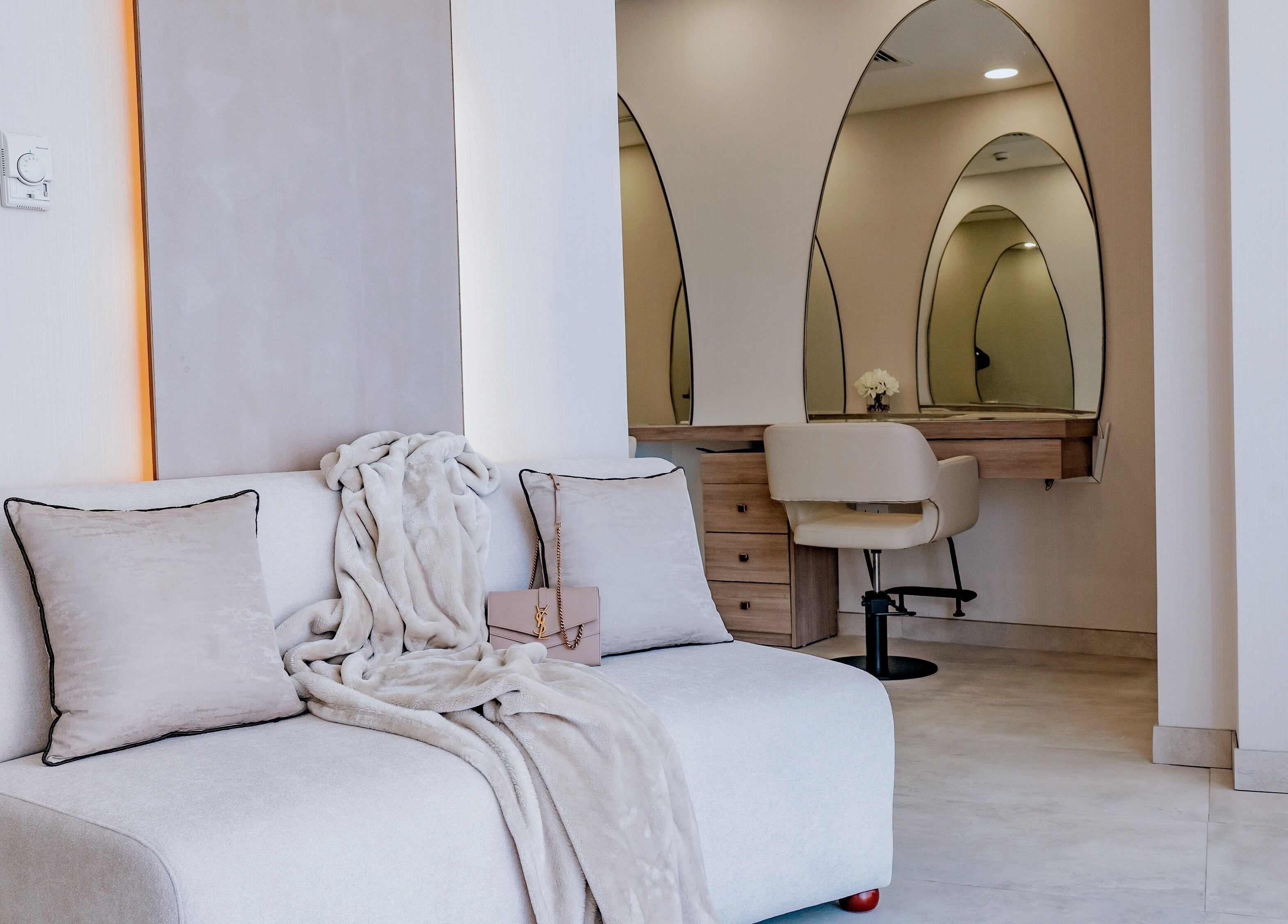 Cozy seating at Lish Beauty Bar - JLT in Dubai, Dubai, AE with mirrors and beauty products on display.