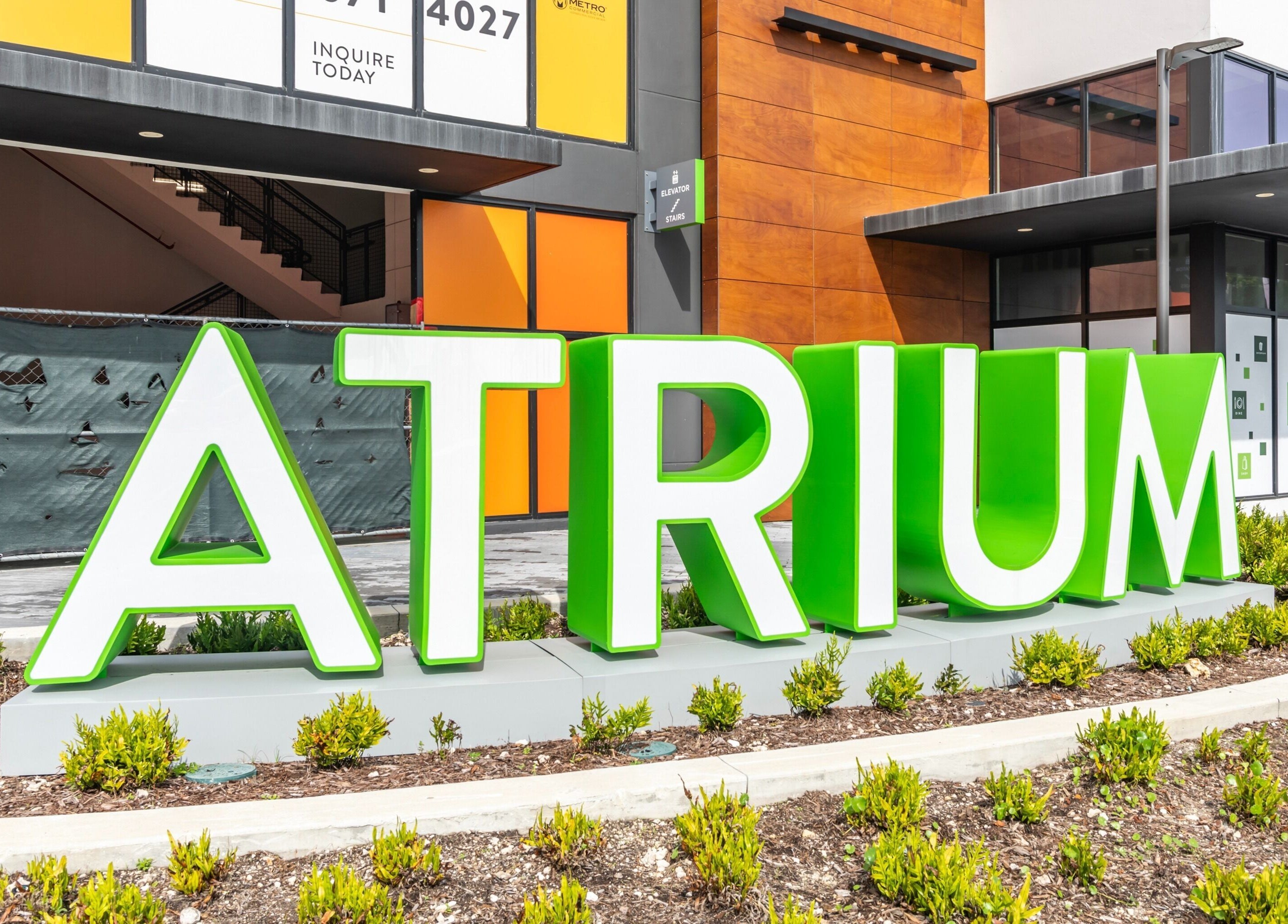 Front view of UMARA's entrance with a bold green 'ATRIUM' sign in Miami, Florida, US.