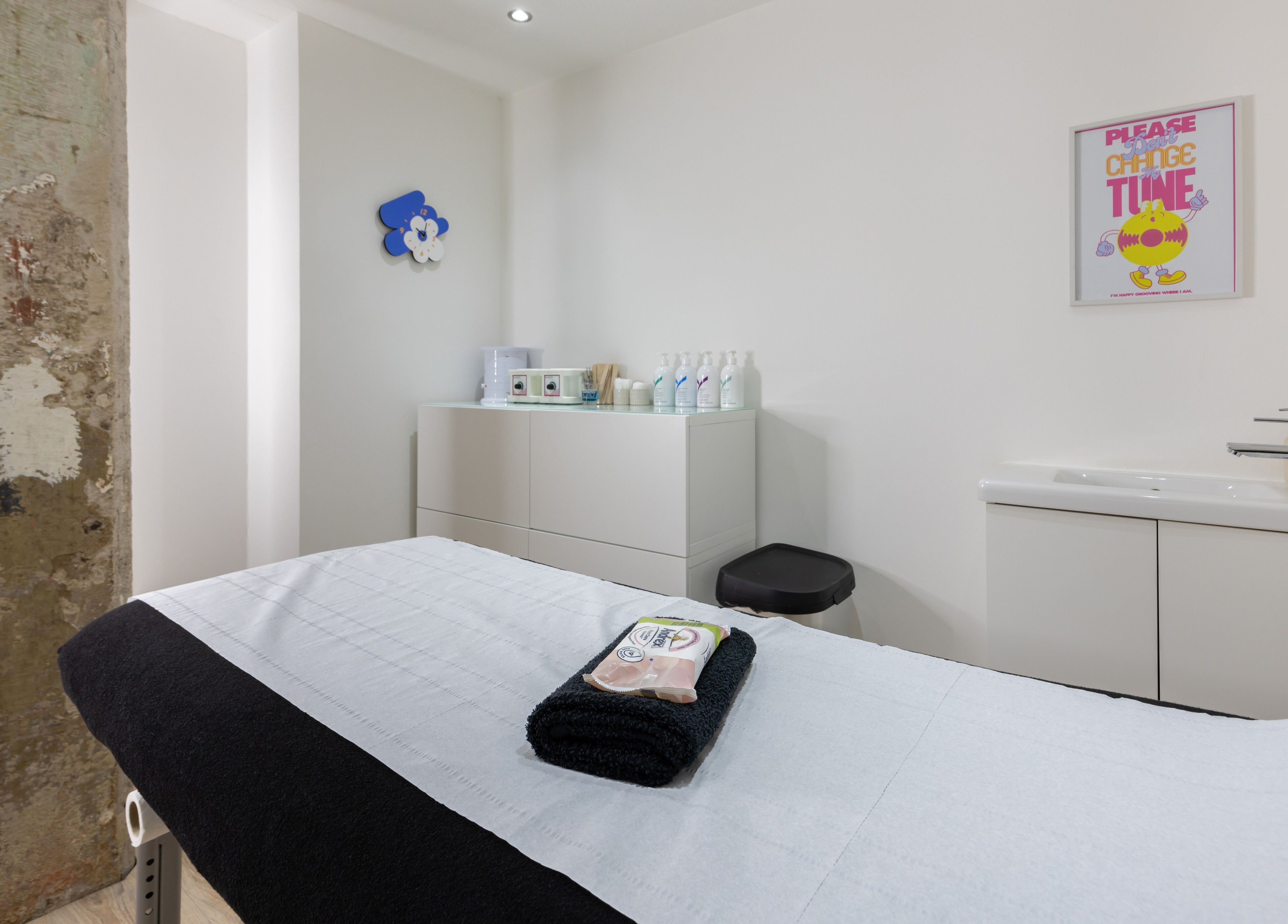 Serene treatment room at Bare Beauty in Edinburgh, Scotland, GB with modern decor and a comfortable bed.