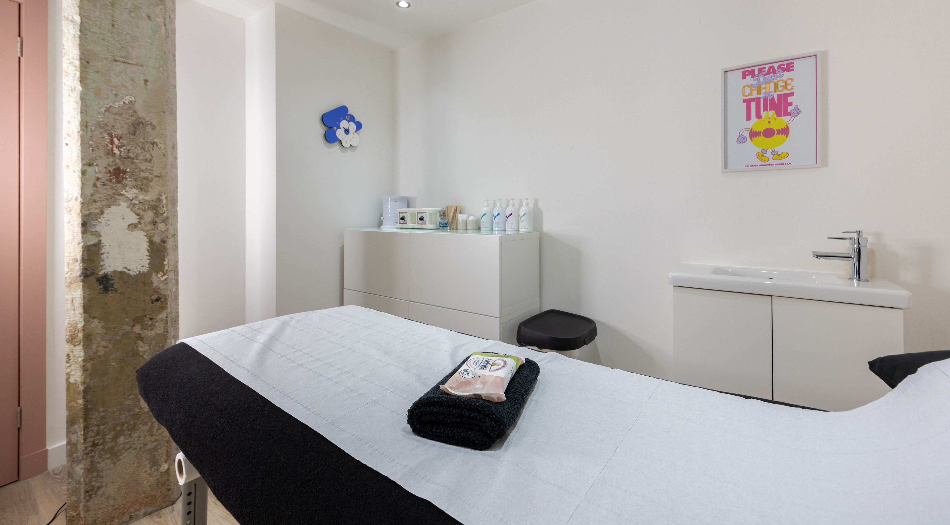 Serene treatment room at Bare Beauty in Edinburgh, Scotland, GB with modern decor and a comfortable bed.