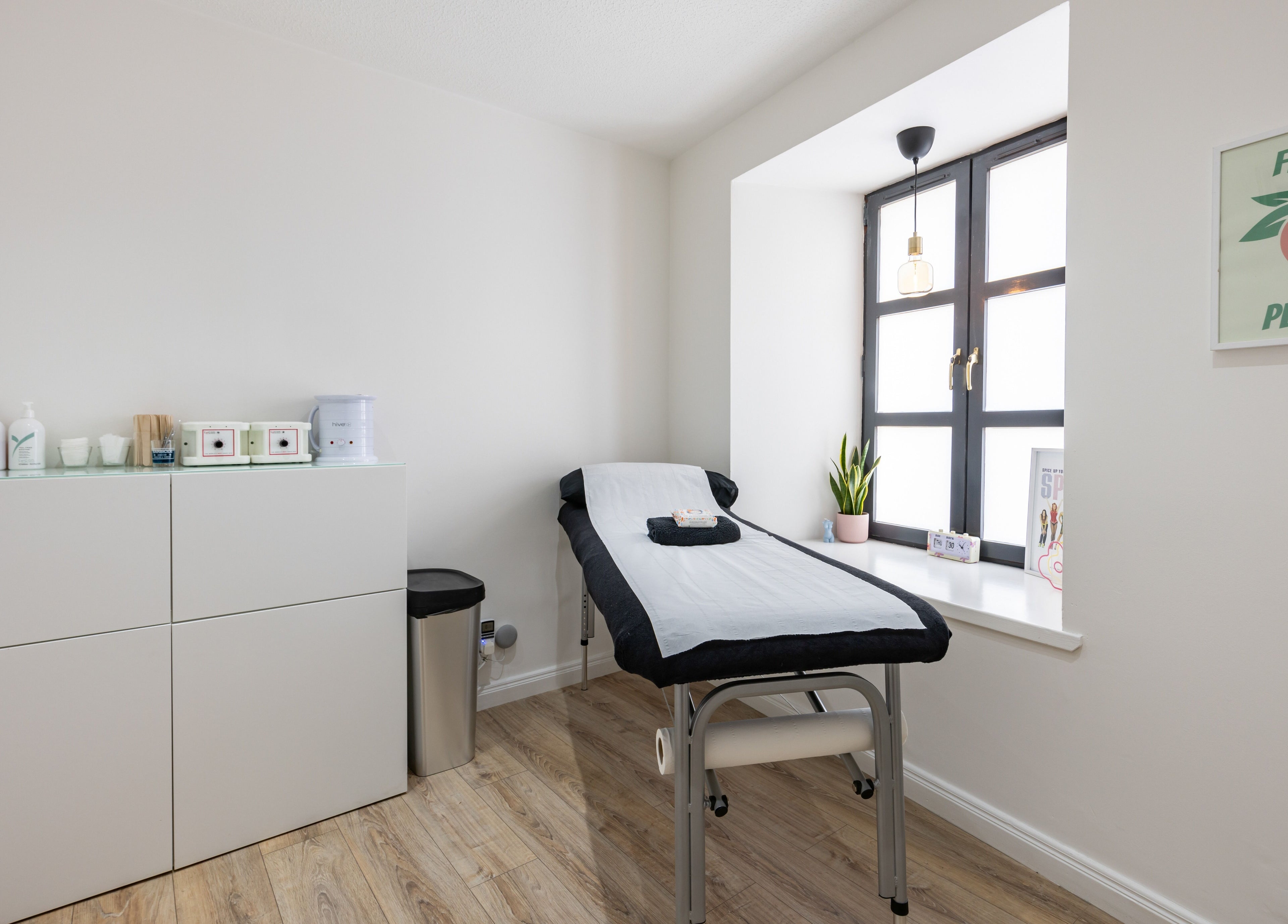 Calm treatment room at Bare Beauty, Edinburgh, Scotland, GB, with a massage bed and natural light.