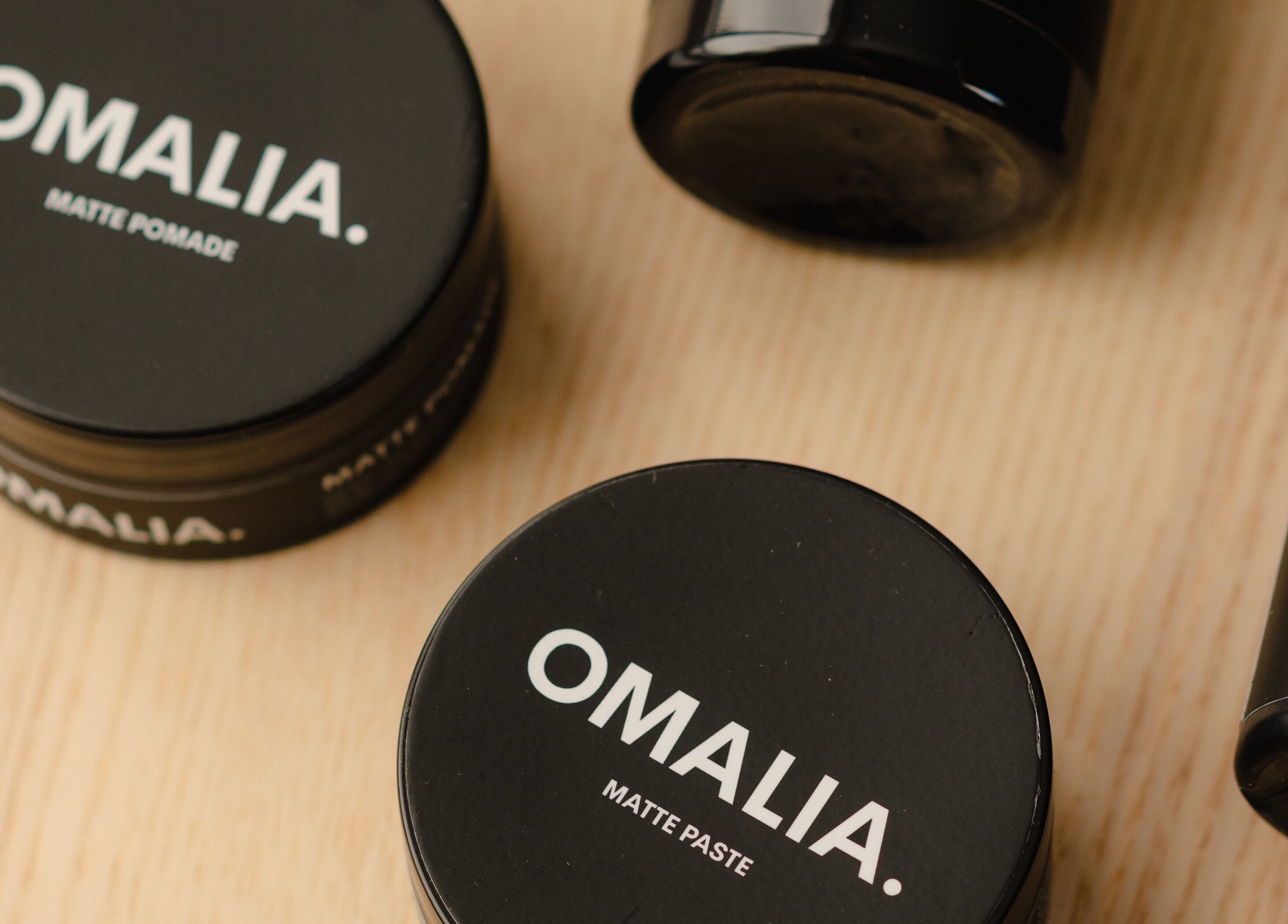 OMALIA. ST LEONARDS hair care products displayed on a wooden surface, St Leonards, New South Wales, AU.