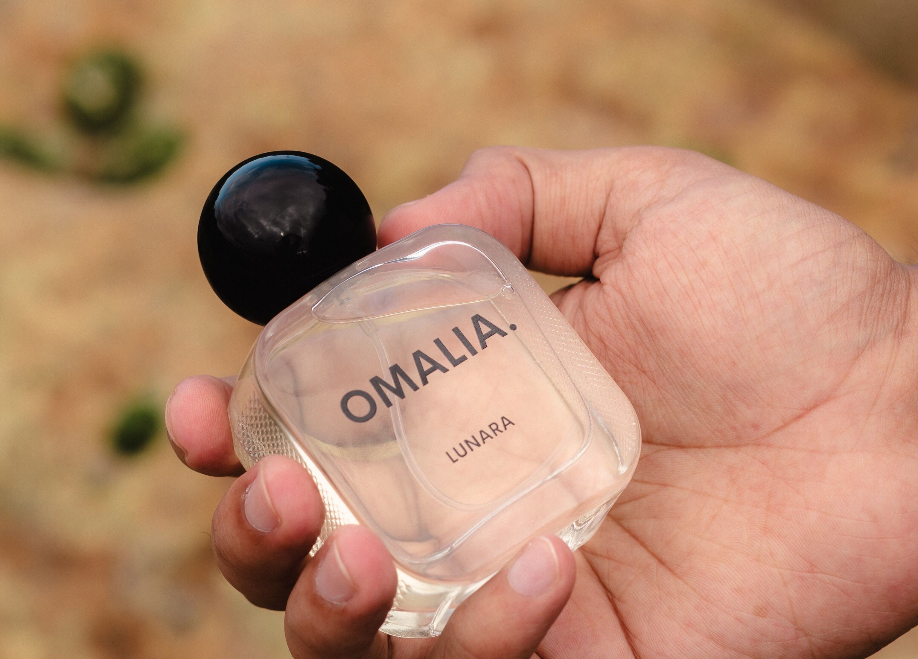 OMALIA perfume bottle held in hand at OMALIA. ST LEONARDS, St Leonards, New South Wales, AU.