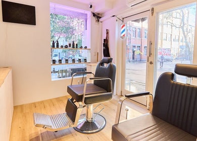 Modern salon interior at OMALIA. SURRY HILLS, featuring sleek chairs and bright decor in Surry Hills, New South Wales, AU.
