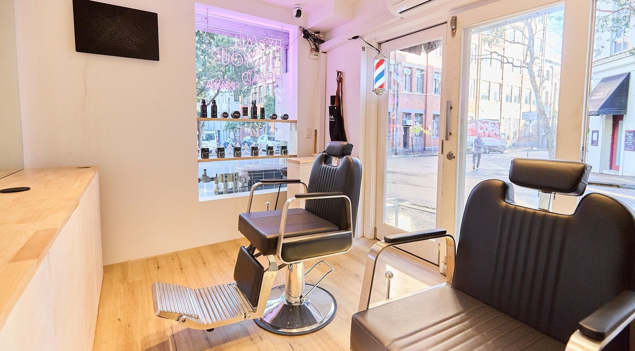 Modern salon interior at OMALIA. SURRY HILLS, featuring sleek chairs and bright decor in Surry Hills, New South Wales, AU.