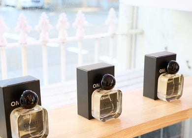 Display of OMALIA perfume bottles at OMALIA. SURRY HILLS, Surry Hills, New South Wales, AU on a wooden shelf.
