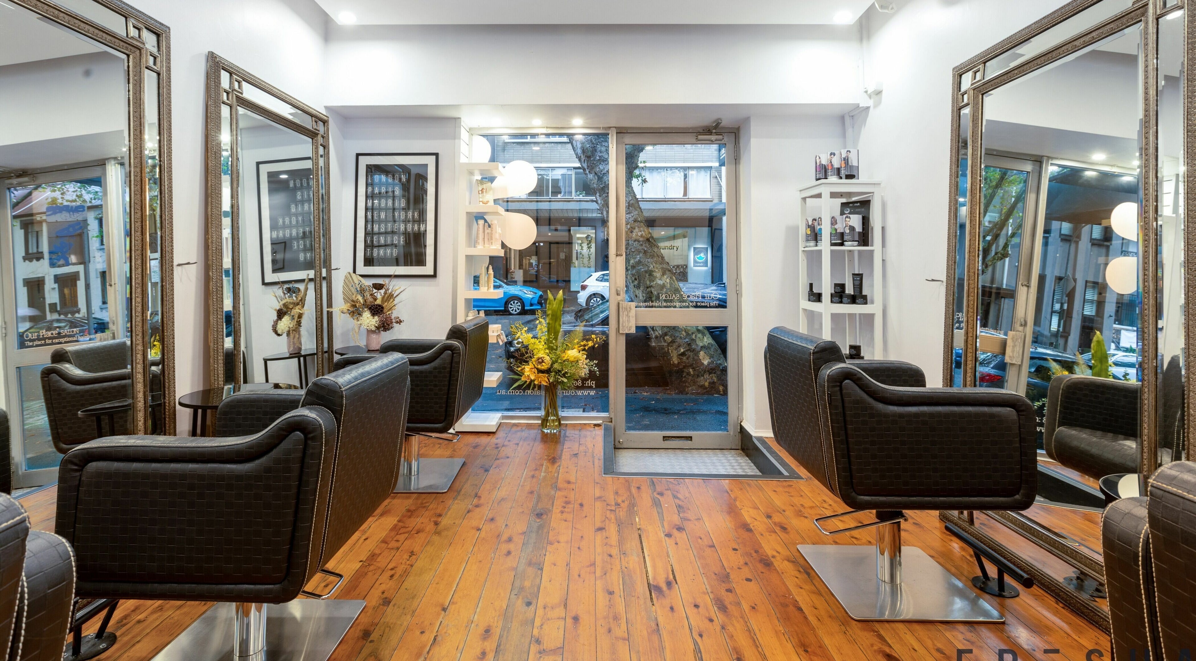 Chic interior of Our Place Salon in Potts Point, New South Wales, AU with stylish chairs and large mirrors.