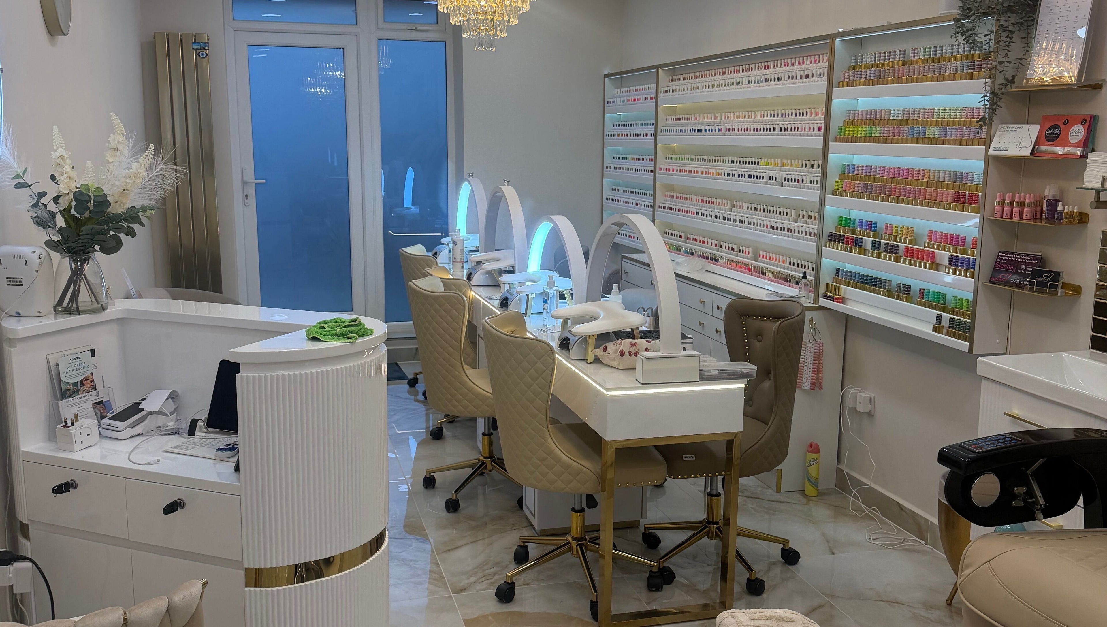Elegant nail station at Polished Beauty, Telscombe Cliffs, England, GB featuring plush chairs and organized shelves.