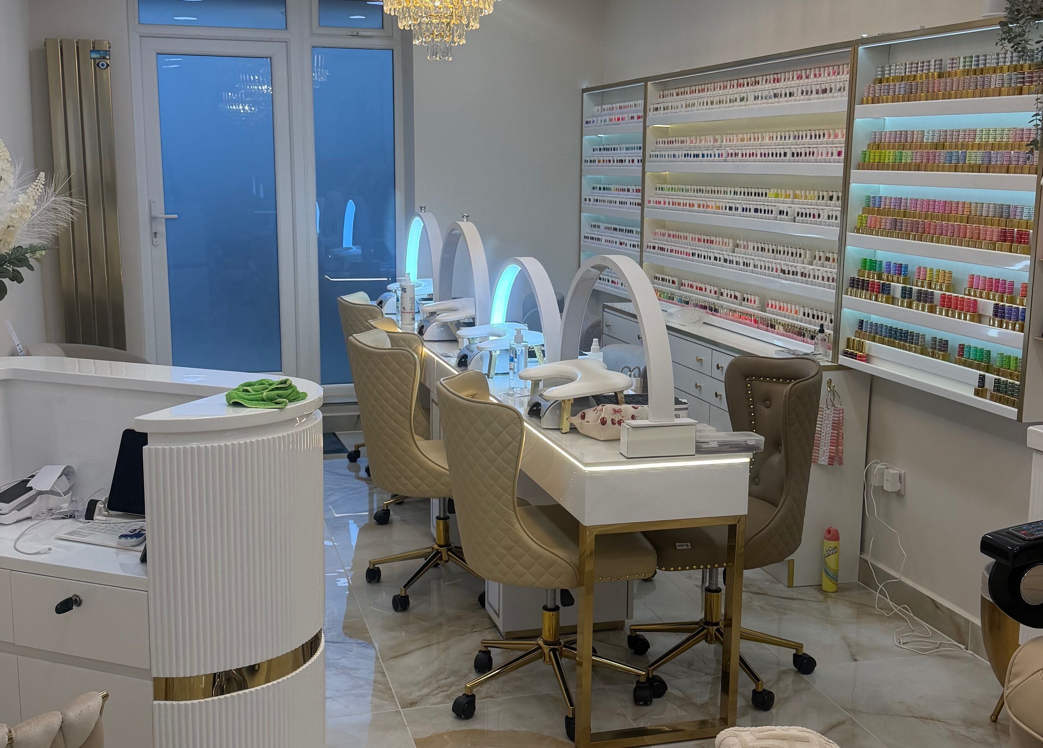 Elegant nail station at Polished Beauty, Telscombe Cliffs, England, GB featuring plush chairs and organized shelves.