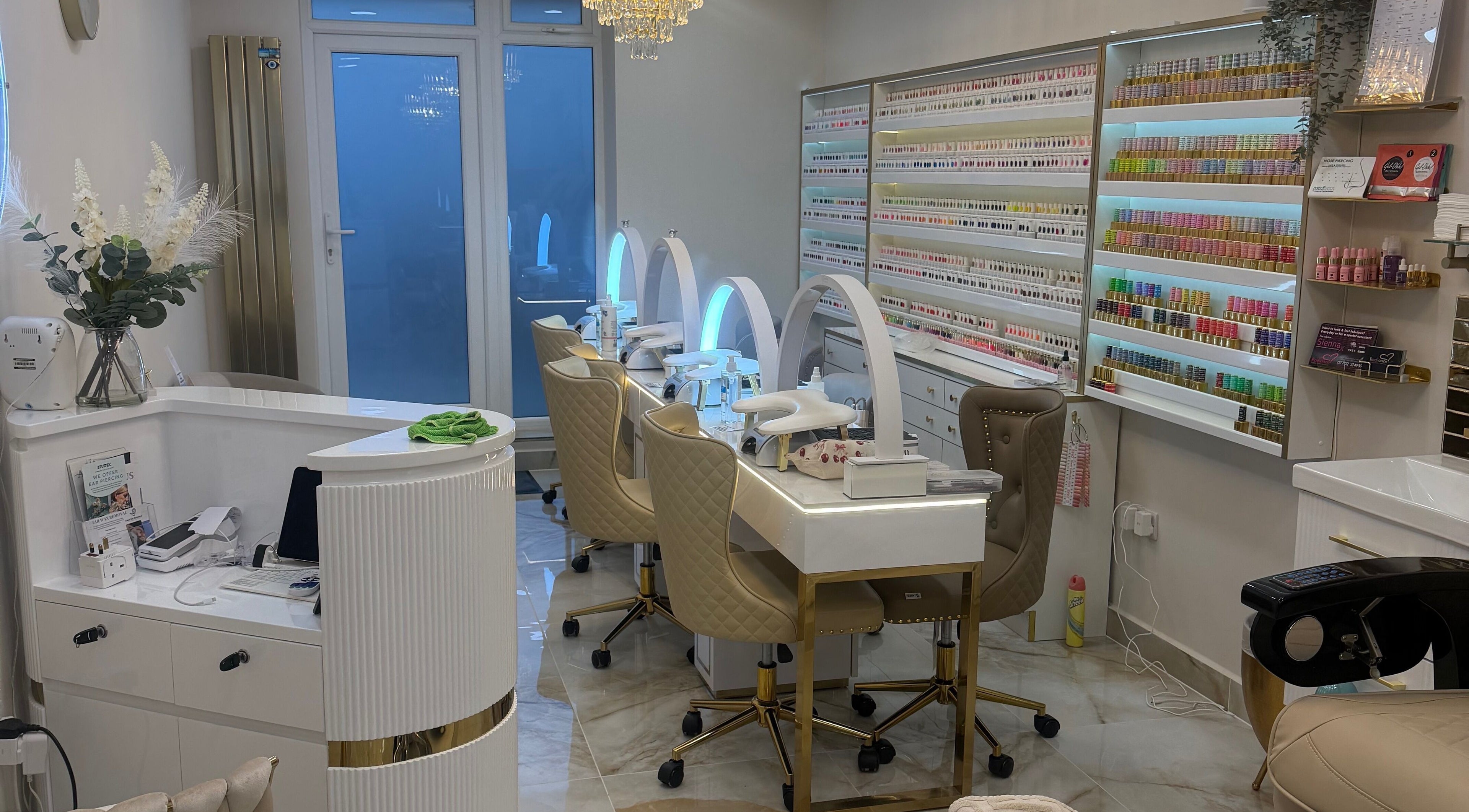 Elegant nail station at Polished Beauty, Telscombe Cliffs, England, GB featuring plush chairs and organized shelves.