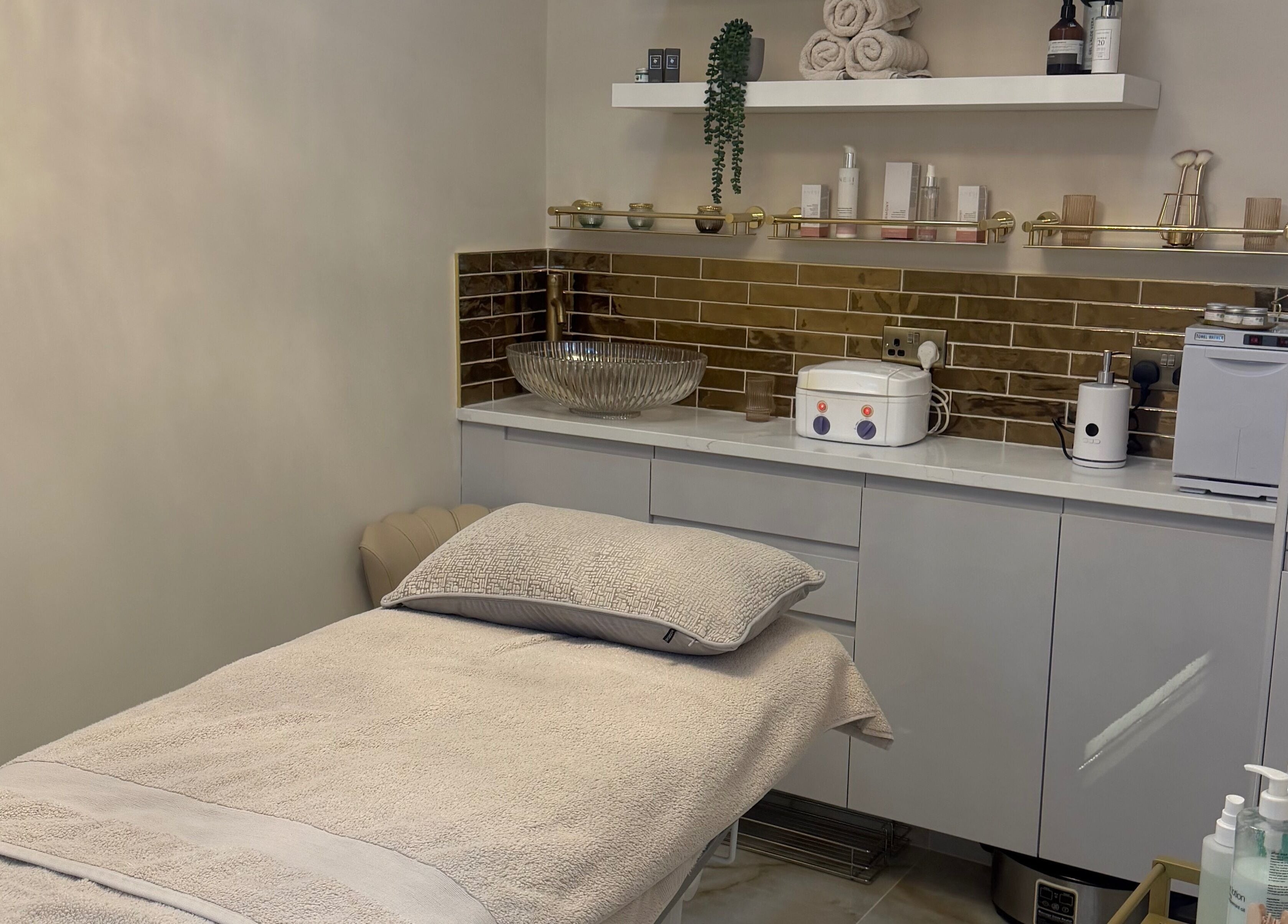 Elegant treatment room at Polished Beauty, Telscombe Cliffs, England, GB, featuring a plush spa bed and modern decor.