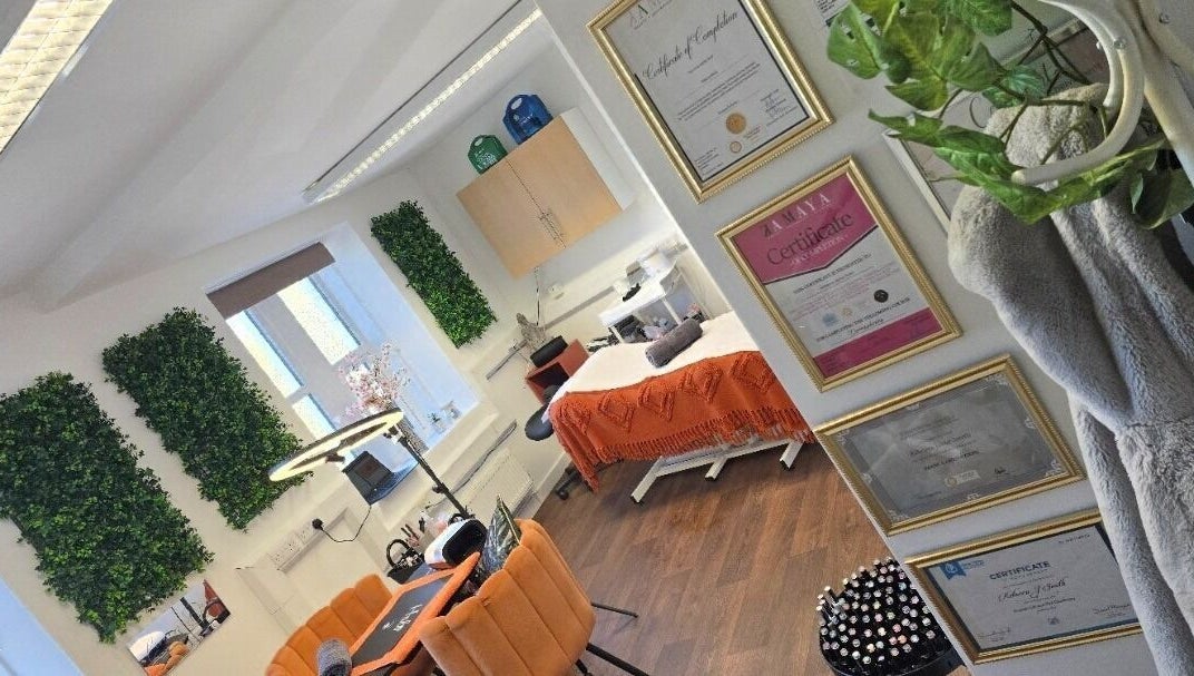 Chic treatment room at Lioness' Den, Elland, England, GB, featuring lush greenery and elegant décor.