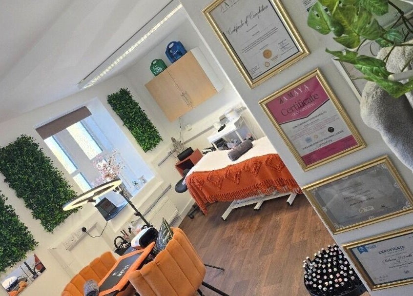 Chic treatment room at Lioness' Den, Elland, England, GB, featuring lush greenery and elegant décor.