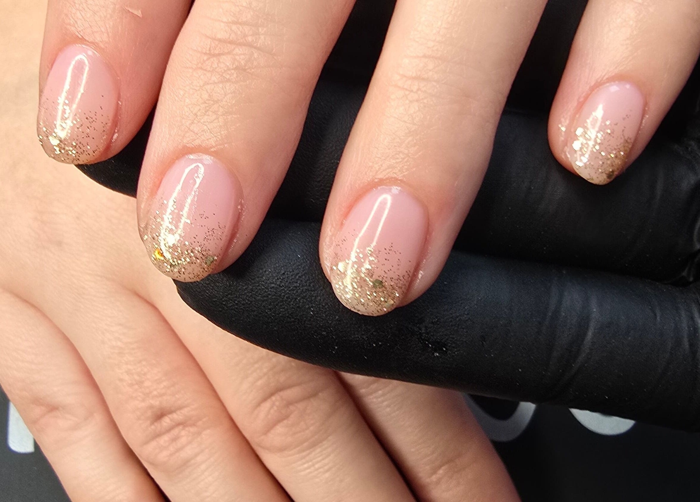 Elegant golden nail art from Lioness' Den, Elland, England, GB.