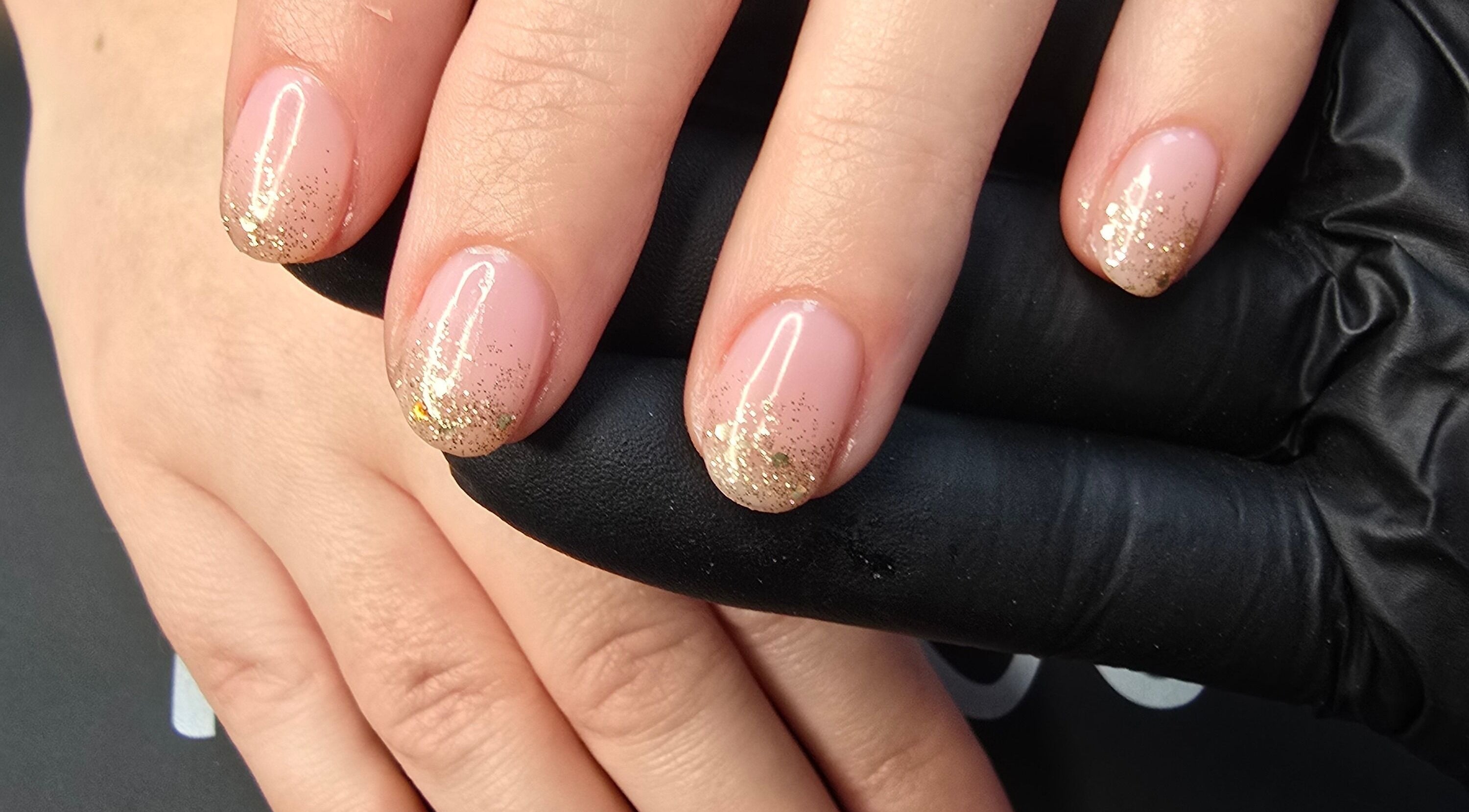 Elegant golden nail art from Lioness' Den, Elland, England, GB.