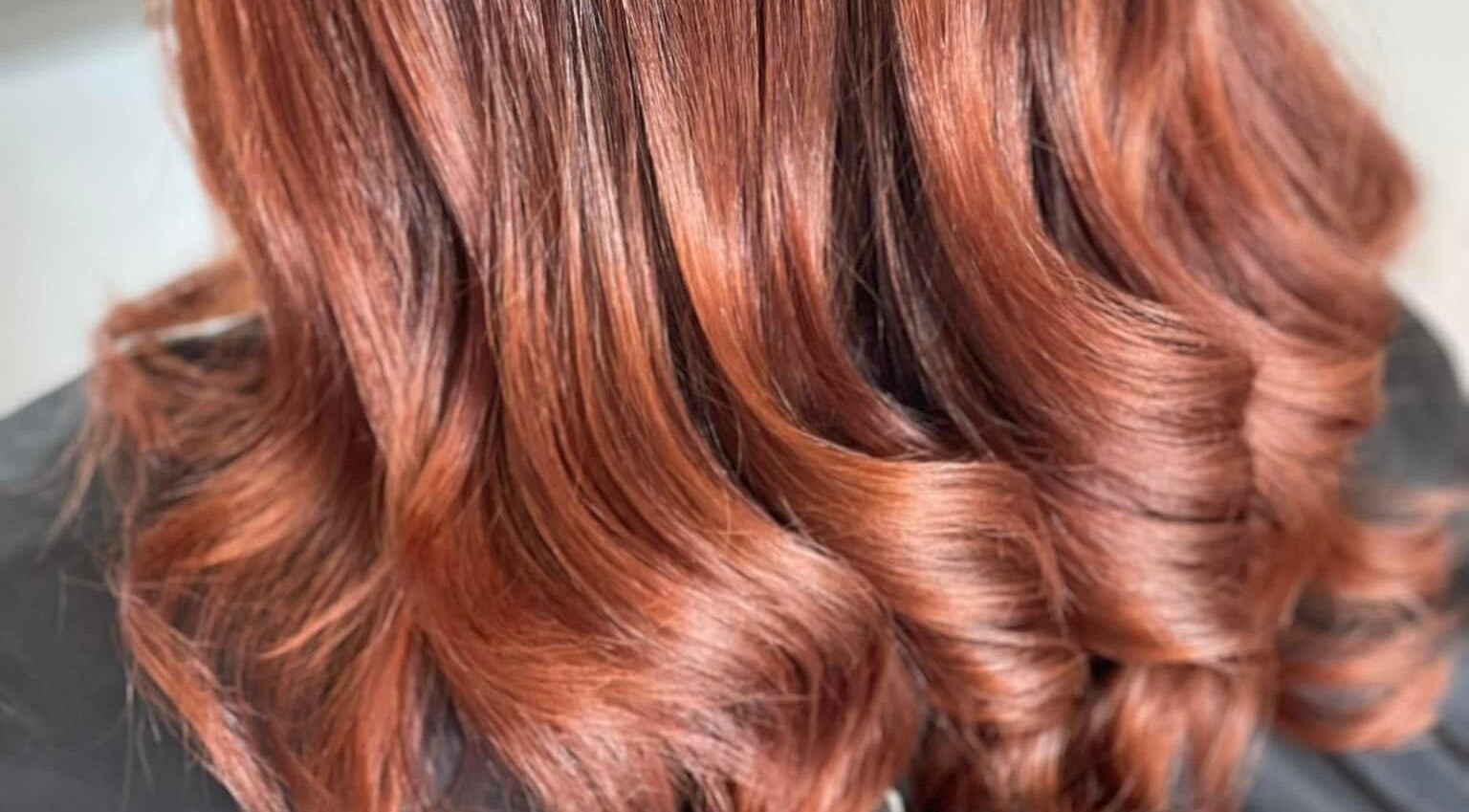 Vibrant copper hair waves styled at Infinity Hair Co, Salamander Bay, New South Wales, AU.