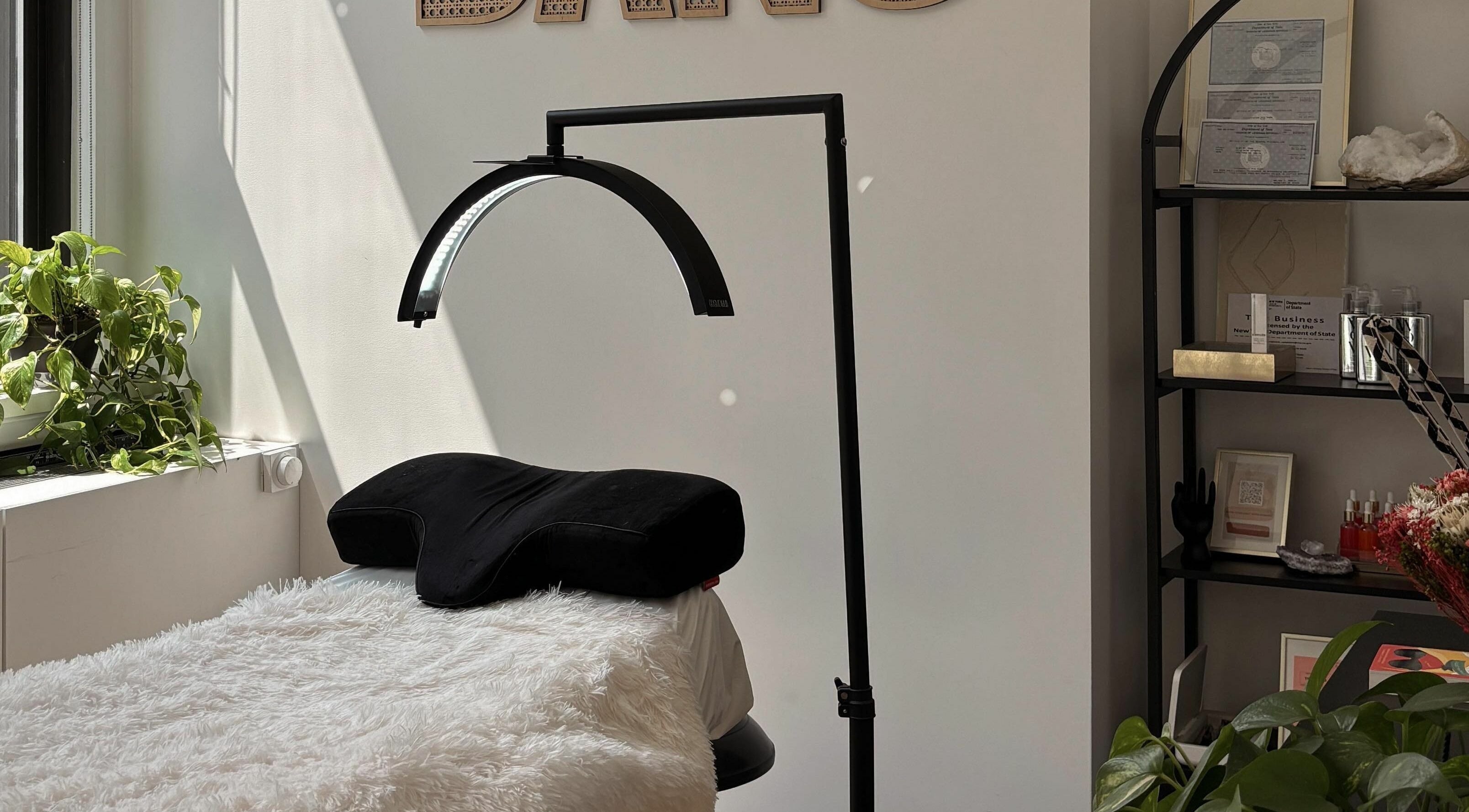 Relaxing treatment area at Glam by Dang, New York, New York, US with bright light and calming decor.