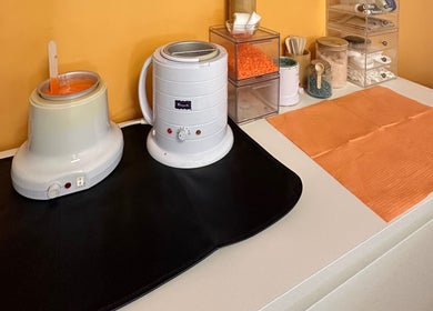Waxing equipment and supplies at Peach Wax Studio, Kelso, Scotland, GB, showcasing a professional setup.