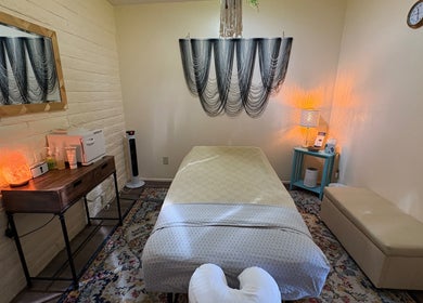 Cozy treatment room at Fusion Therapeutic Bodywork in Tucson, Arizona, US, with massage table and warm lighting.