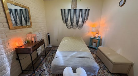 Cozy treatment room at Fusion Therapeutic Bodywork in Tucson, Arizona, US, with massage table and warm lighting.