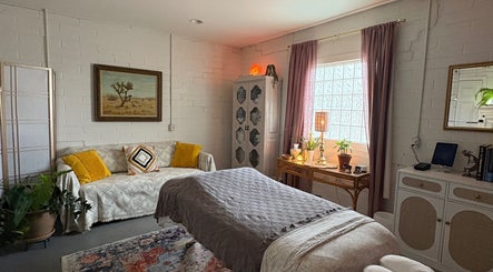 Relaxing massage room at Fusion Therapeutic Bodywork, Tucson, Arizona, US with cozy decor and soft lighting.