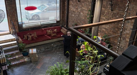 Warm, inviting lounge area at ByDivine Lash Artistry in Melbourne, Victoria, AU with rustic decor.