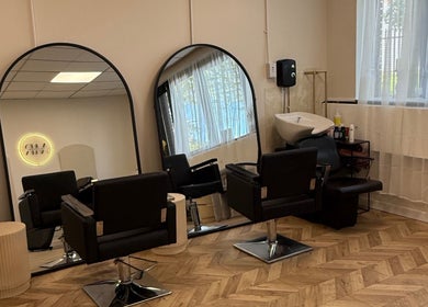 Modern salon interior at Megan Reid Hair Design, Clydebank, Scotland, GB showcasing stylish chairs and mirrors.