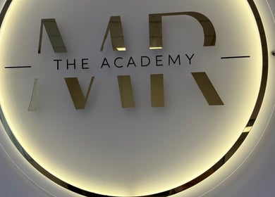 Illuminated logo at Megan Reid Hair Design in Clydebank, Scotland, GB showcases stylish branding.