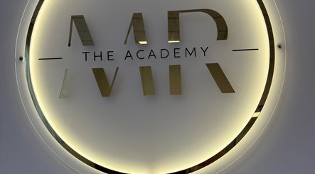 Illuminated logo at Megan Reid Hair Design in Clydebank, Scotland, GB showcases stylish branding.