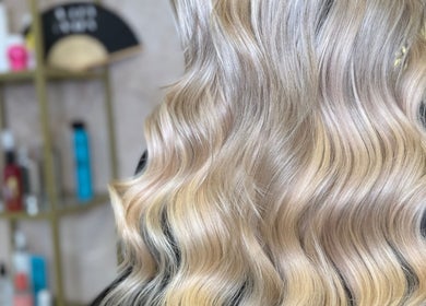 Blonde wavy hair styled at Megan Reid Hair Design, Clydebank, Scotland, GB. Sleek, shiny, and expertly crafted.