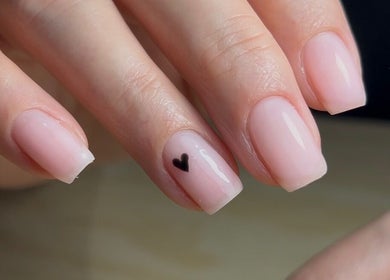 Elegant light pink nails with a heart design at Jessica Beauty Babe Nails in Abercynon, Wales, GB.