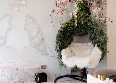 Chic waiting area with floral chair at MW Nails and Beauty Salon, London, England, GB.