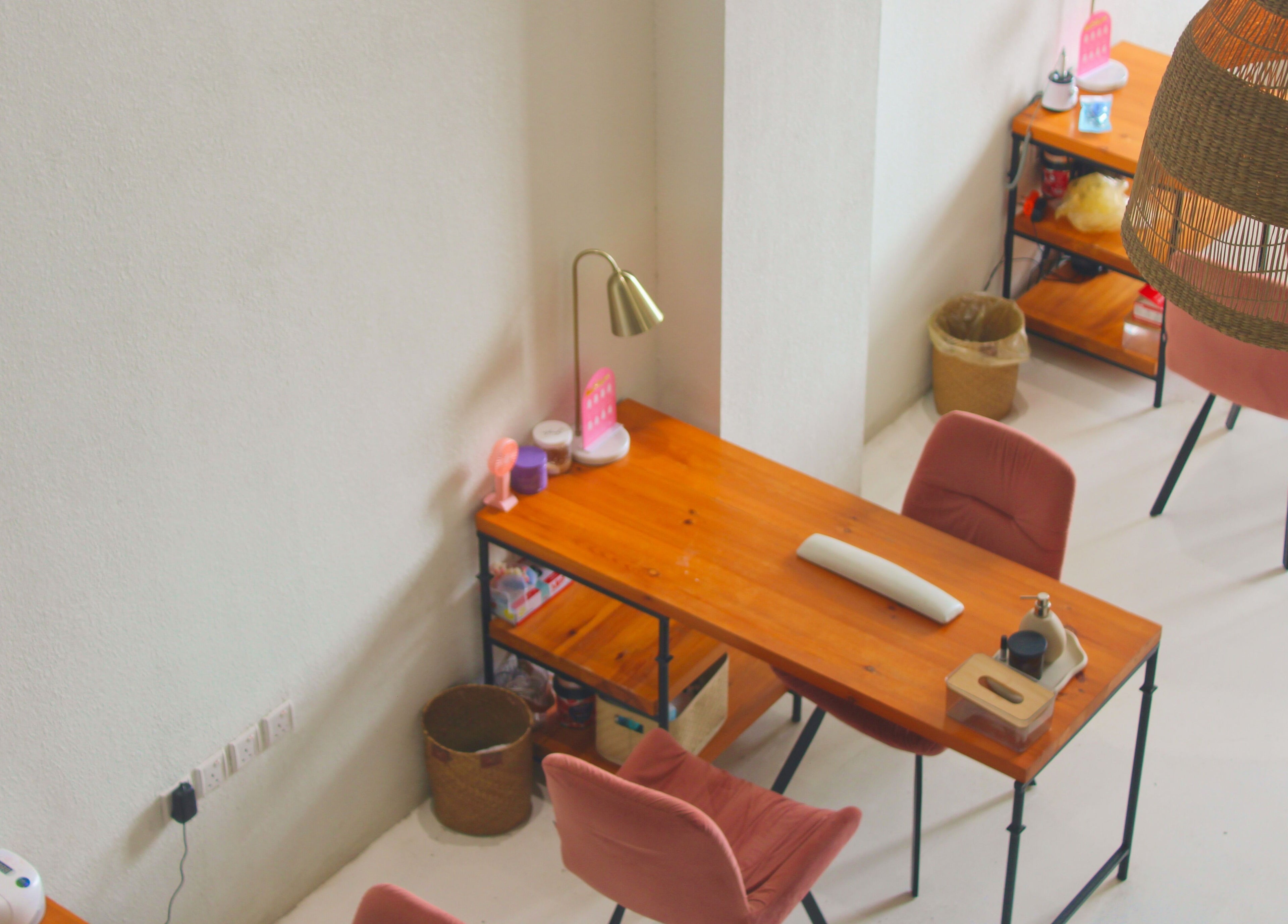 Inviting salon work desk setup at Nash ناش, Riyadh, Riyadh Province, SA with warm lighting and chairs.