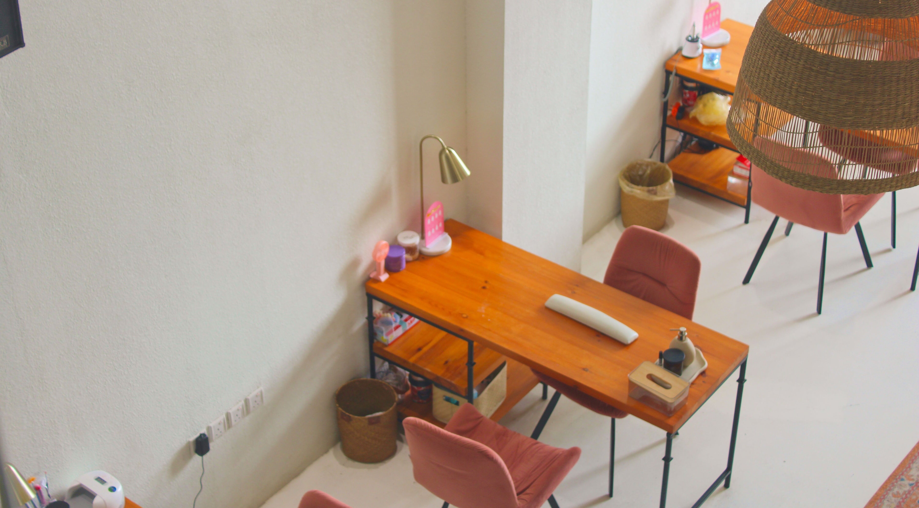 Inviting salon work desk setup at Nash ناش, Riyadh, Riyadh Province, SA with warm lighting and chairs.