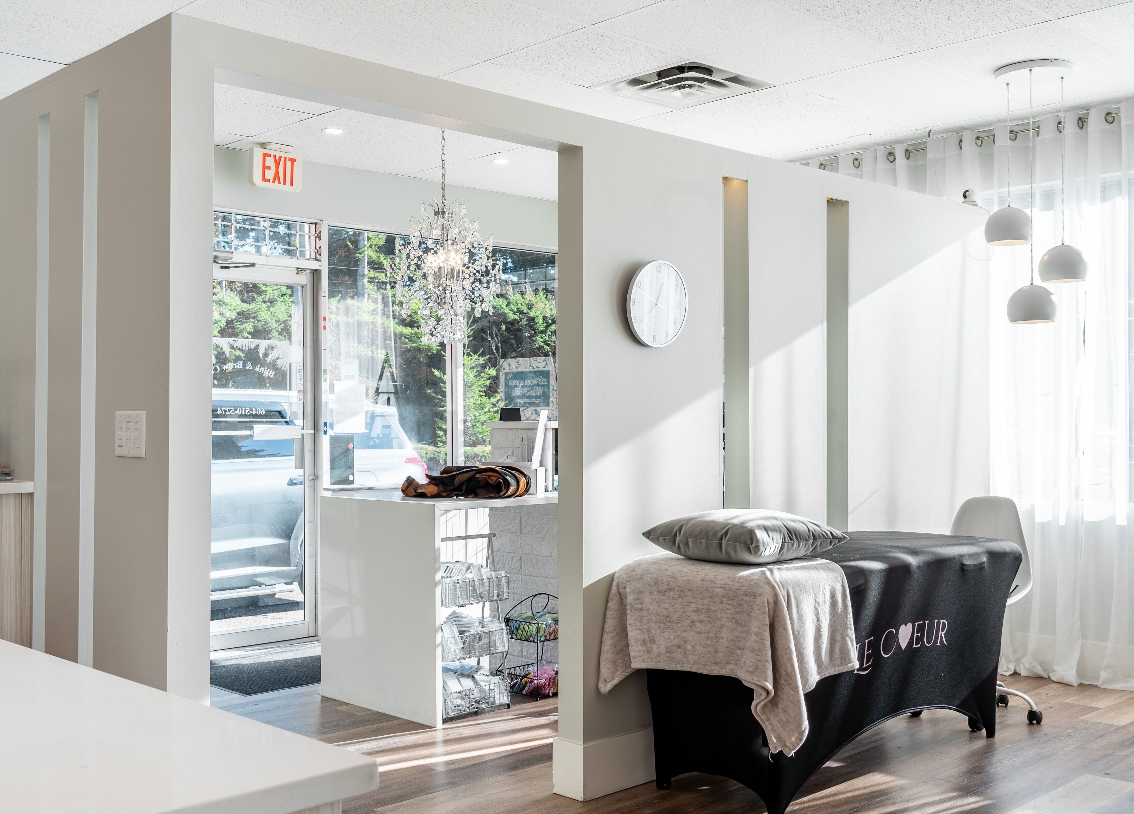 Interior of Blink & Brow Co. BROOKSWOOD, Langley Township, BC, featuring elegant decor and a cozy treatment area.