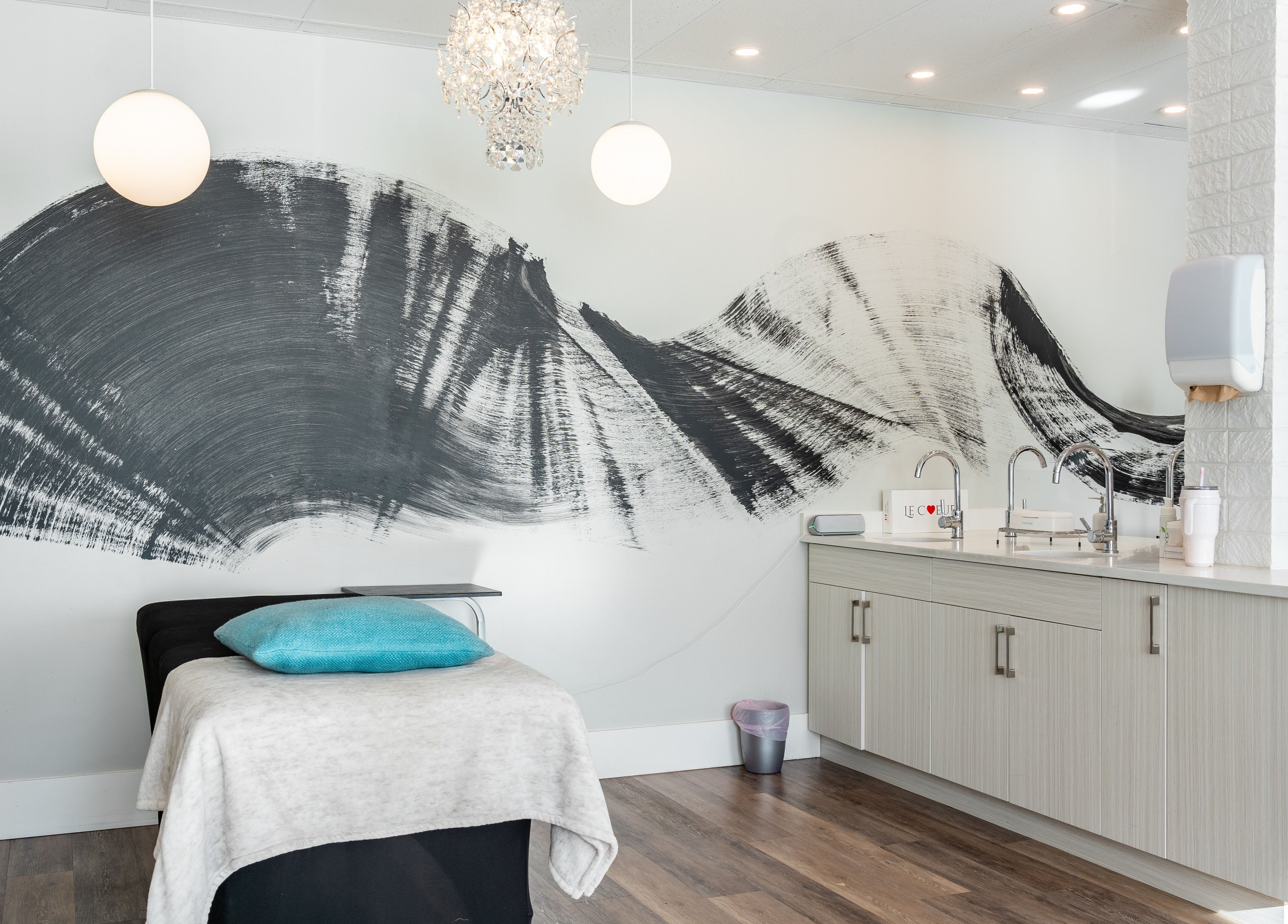 Modern treatment room at Blink & Brow Co. BROOKSWOOD, Langley Township, BC, featuring a stylish black brushstroke mural.