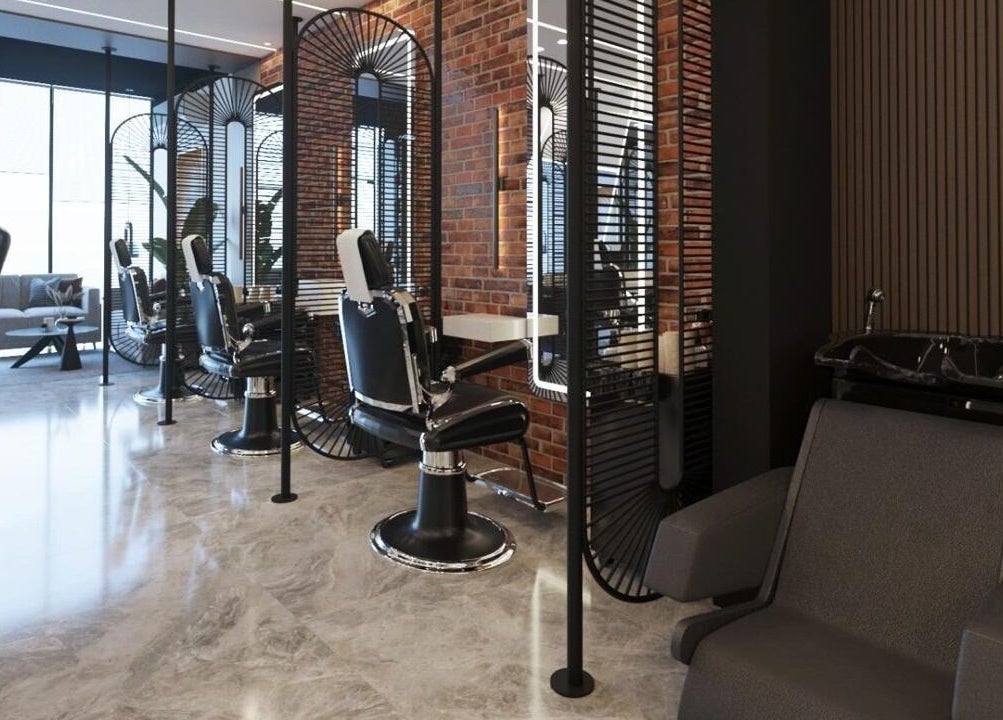 Modern interior of Pointcut Barbershop in Riyadh, featuring sleek barber chairs and chic decor.