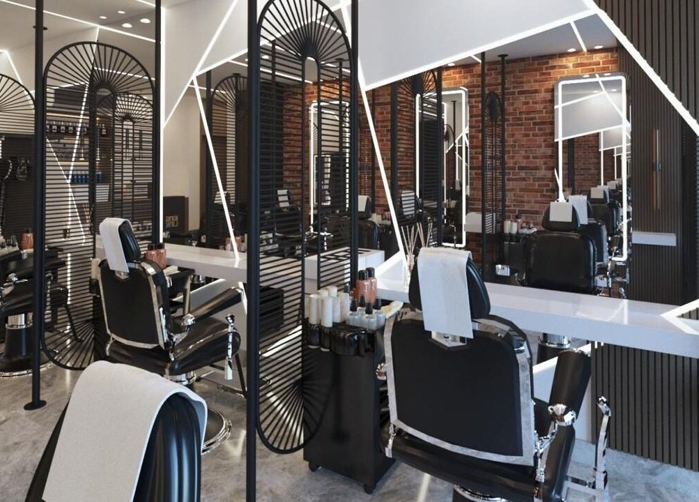 Modern interior of Pointcut Barbershop, Riyadh, showing sleek barber chairs and stylish decor.
