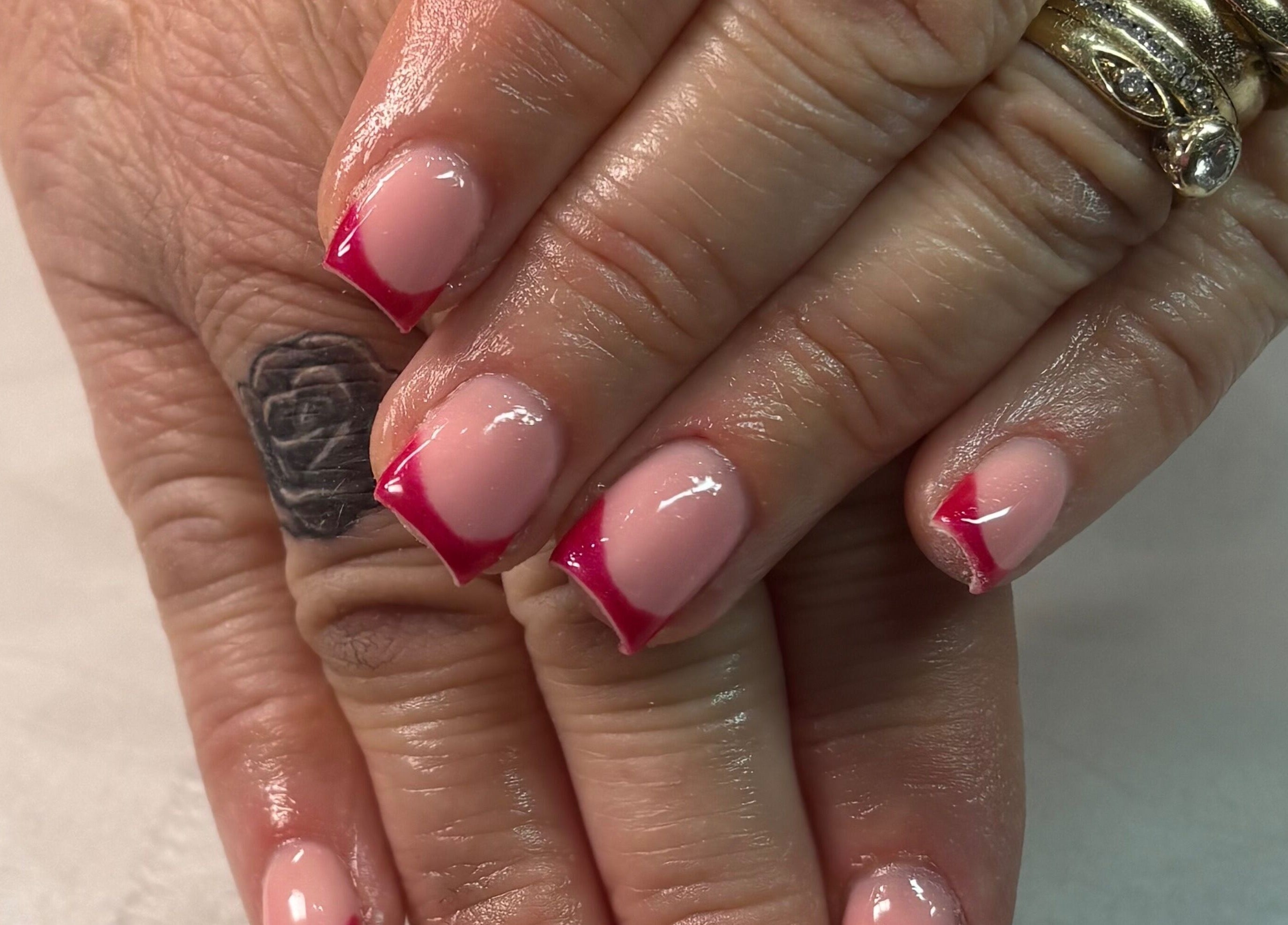 Elegant red-tipped manicure at Megs Beauty Bar, Little Lever, England, GB offering premium nail services.