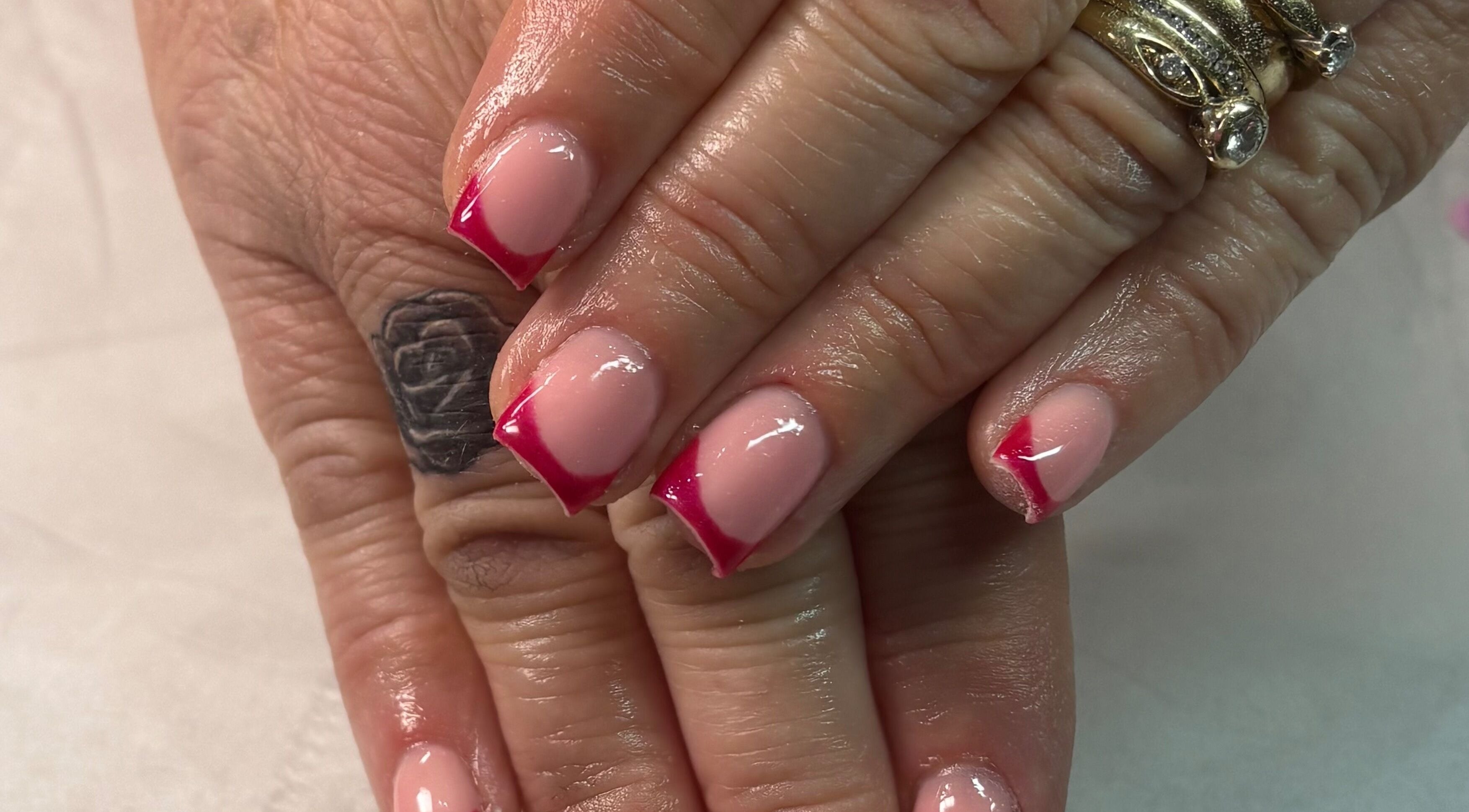 Elegant red-tipped manicure at Megs Beauty Bar, Little Lever, England, GB offering premium nail services.