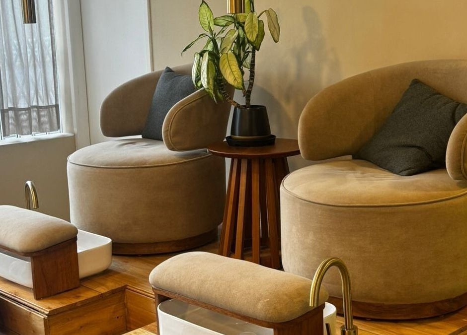 Espacio de descanso elegante en Naturale, Quito, Pichincha, EC, con sillas cómodas y detalles de planta decorativa.