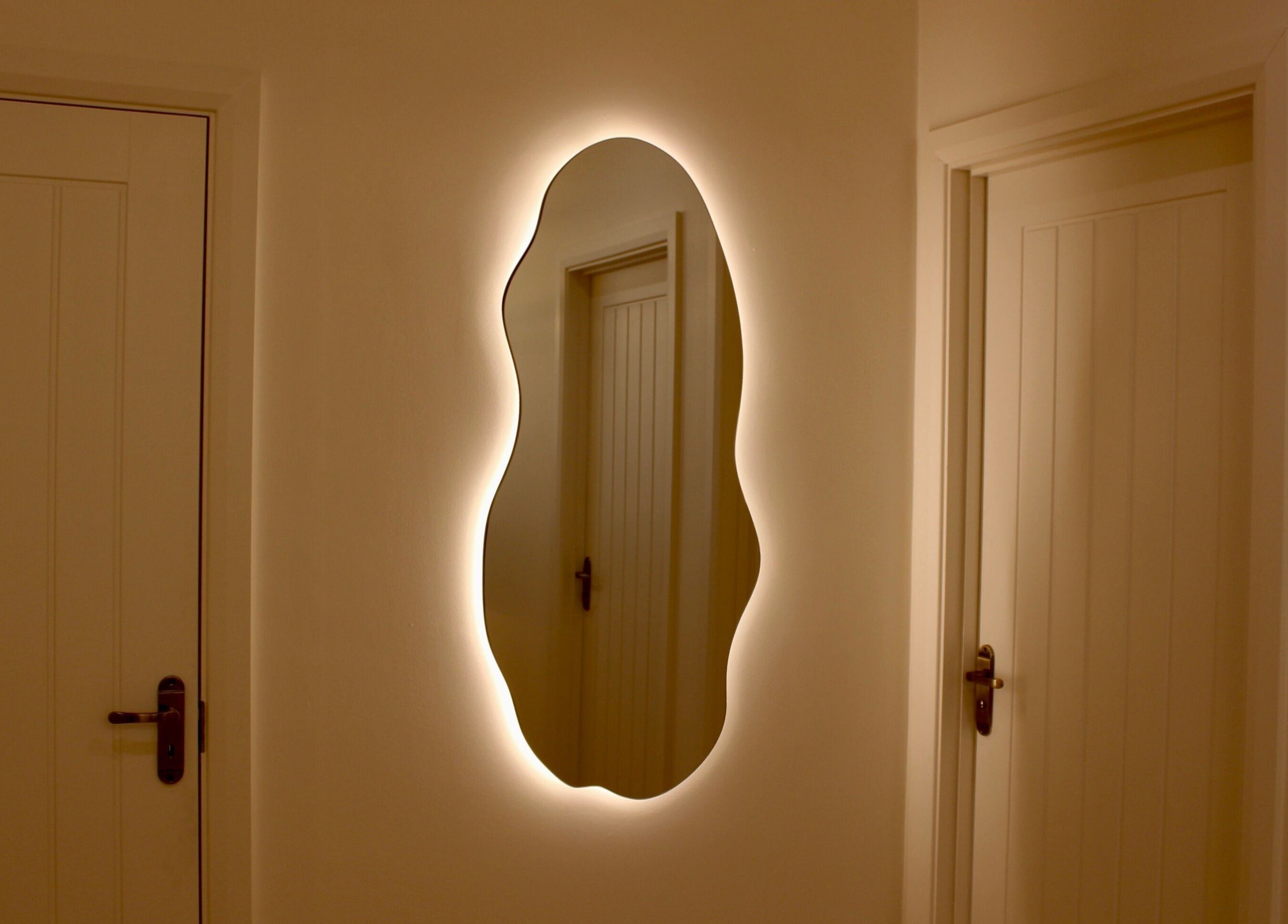 Elegant wavy mirror with ambient backlighting at Love T Waxing and Laser Specialist Studio, Mansfield, England, GB.