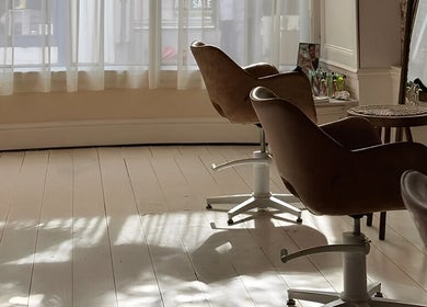 Elegant interior of Morgelyn Studio, Penzance, England, GB, featuring stylish salon chairs and natural light.