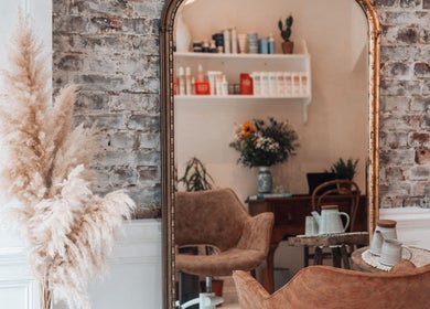 Chic interior at Morgelyn Studio in Penzance, England, GB, featuring rustic decor and elegant mirror.