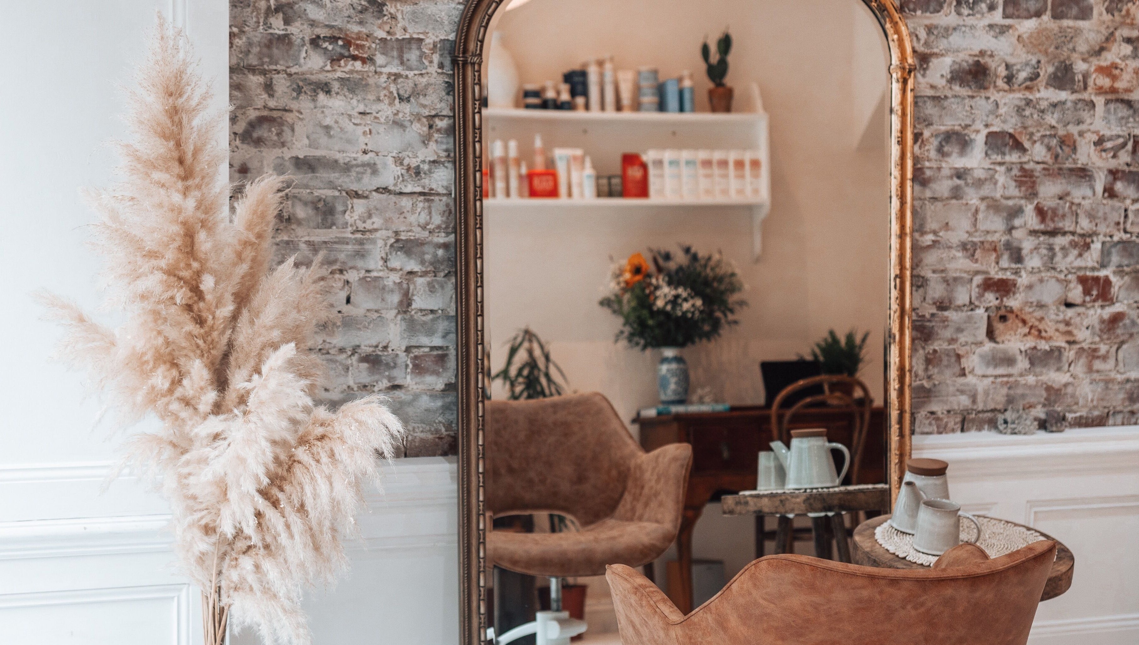 Chic interior of Morgelyn Studio in Penzance, England with vintage decor and plush seating.