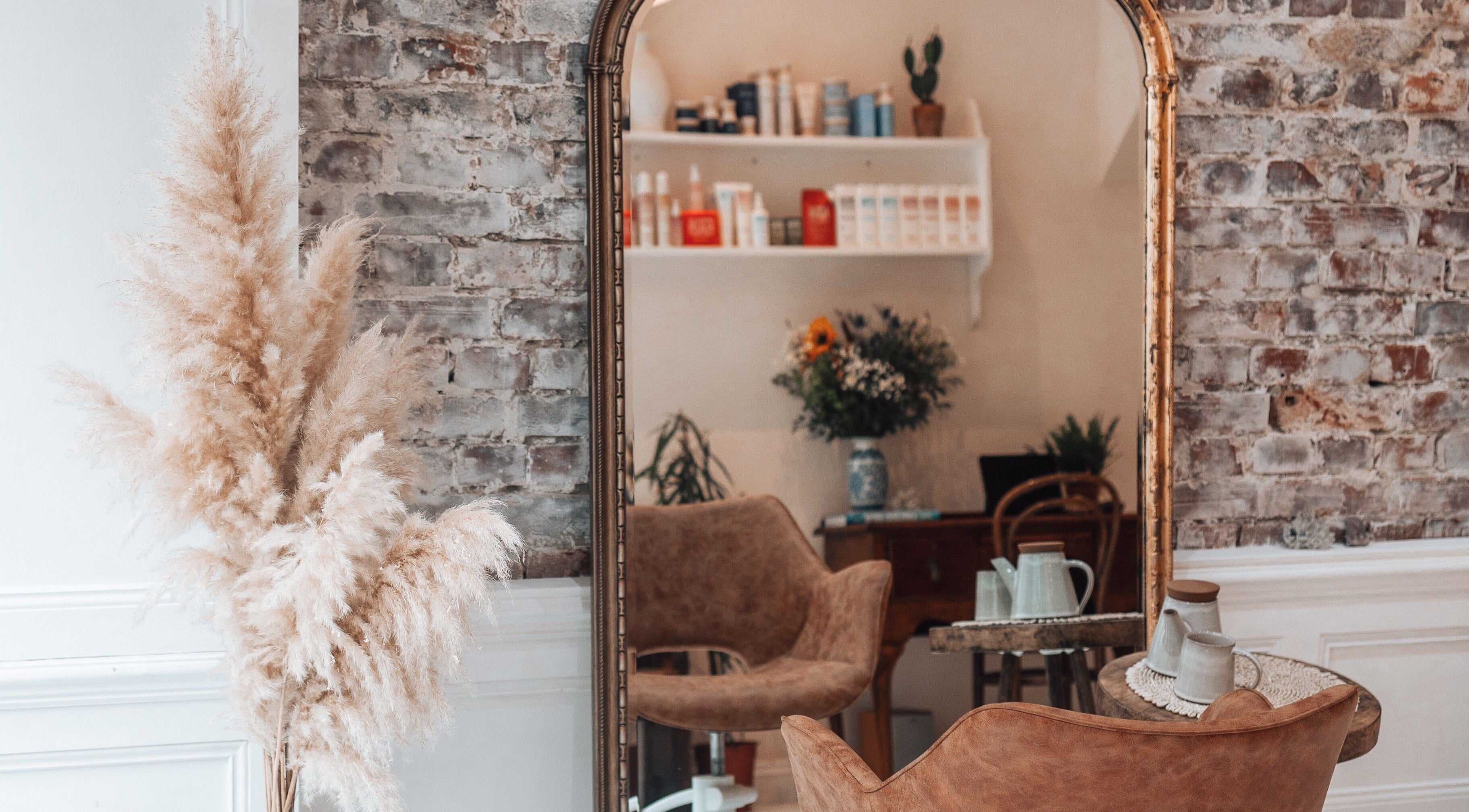 Chic interior of Morgelyn Studio in Penzance, England with vintage decor and plush seating.