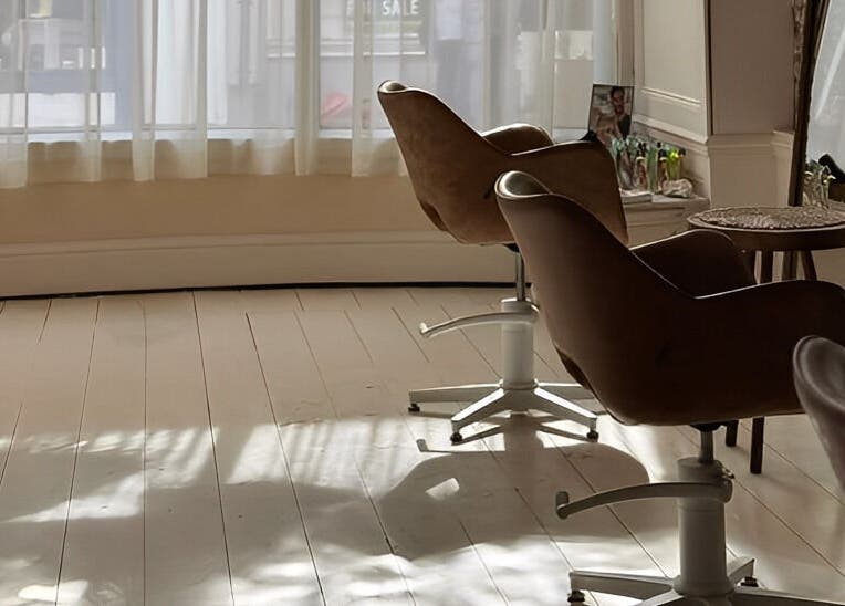 Bright salon chairs by a sunlit window at Morgelyn Studio, Penzance, England, GB, showcasing a tranquil space.