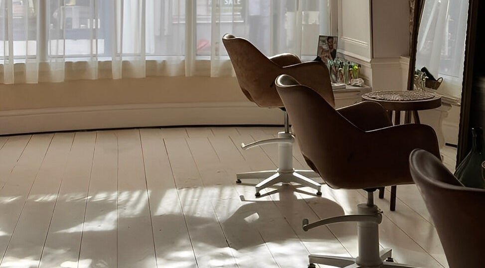 Bright salon chairs by a sunlit window at Morgelyn Studio, Penzance, England, GB, showcasing a tranquil space.
